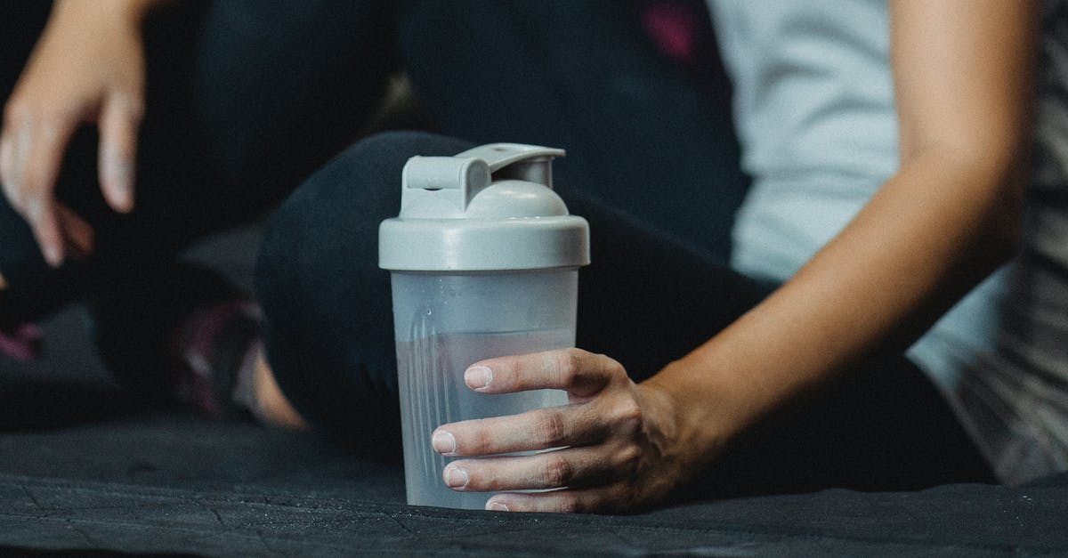 Is the tapwater fit to drink throughout Taiwan? - Side view crop sportswoman sitting on floor with water bottle and resting after intense training