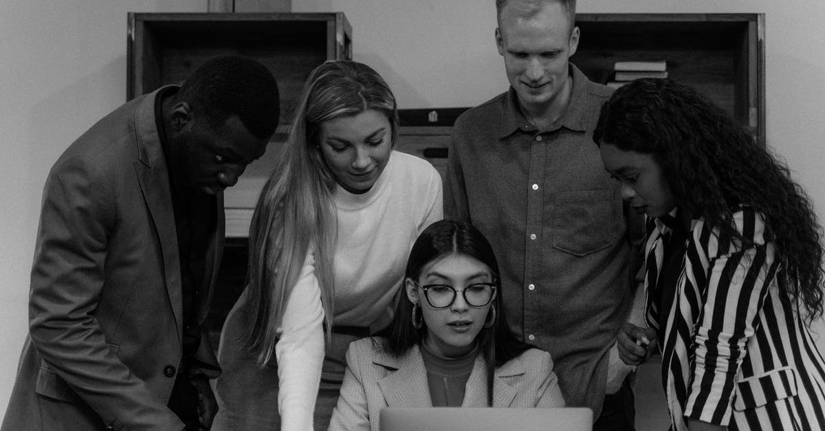 Is the UK planning to introduce exit checks in 2015? - Grayscale Photo of People Looking at the Laptop Screen 