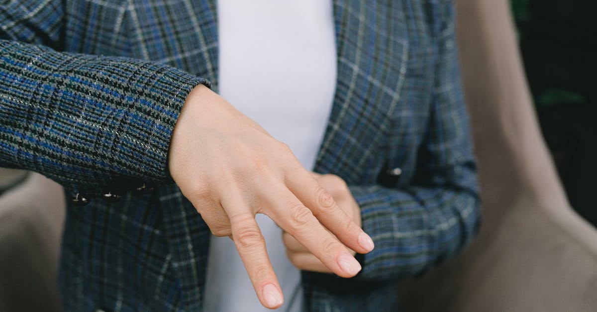 Is the word “bomb” muted in in-flight movies? - Faceless lady showing three fingers gesture while practicing sign language