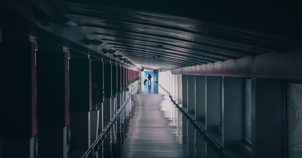 Is there a bar at Incheon airport? - A Person Walking at the Corridor