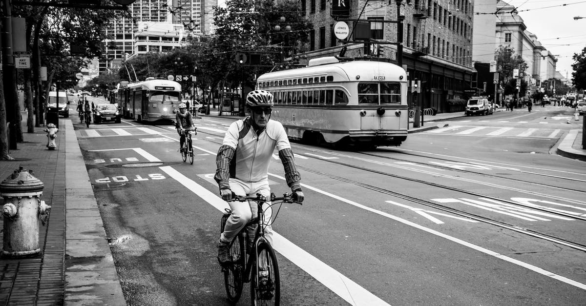 Is there a bus from San Francisco to Sonoma? - Grayscale Photo of Man Riding Bicycle on Street