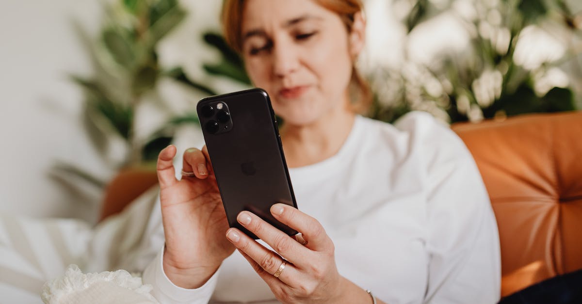 Is there a Canadian equivalent to Mobile Passport? - Woman in White Dress Shirt Holding Black Iphone 7 Plus