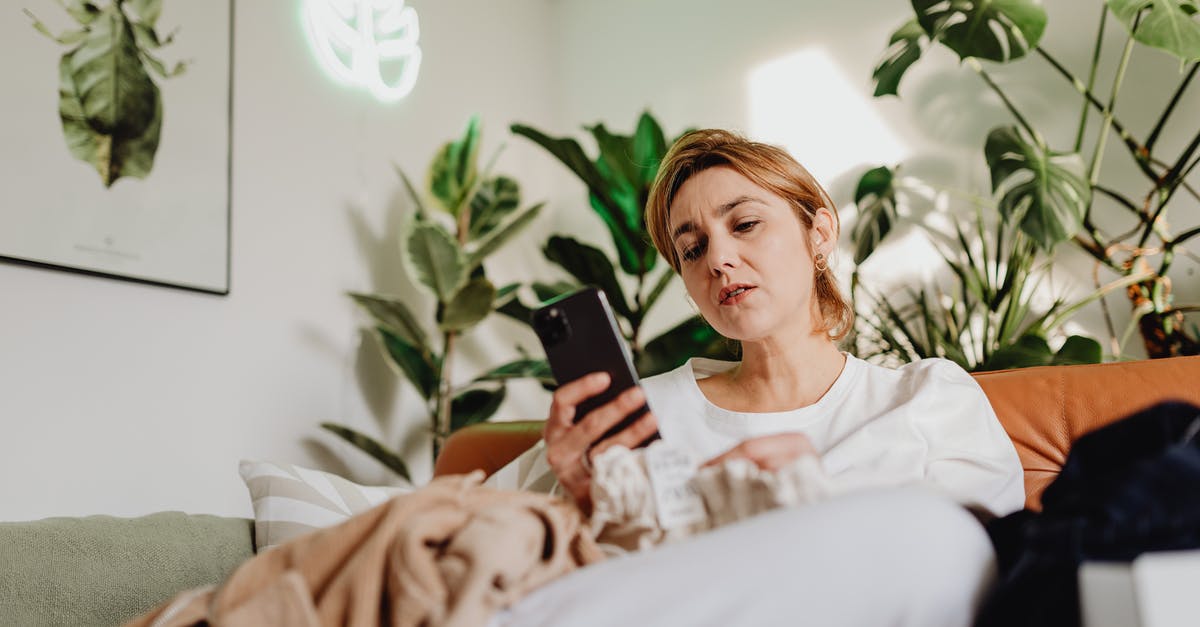 Is there a Canadian equivalent to Mobile Passport? - Woman Sitting on a Couch and Using a Phone 