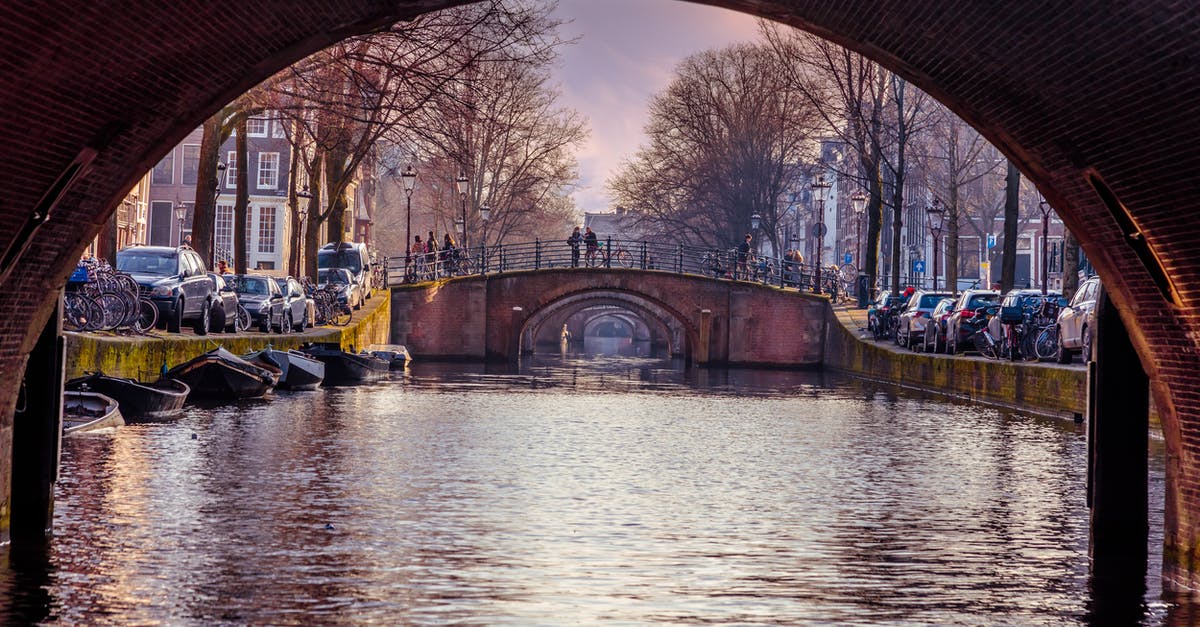 Is there a city in the world with more bridges than Amsterdam, the Netherlands? - Brown Bridge Between Vehicles