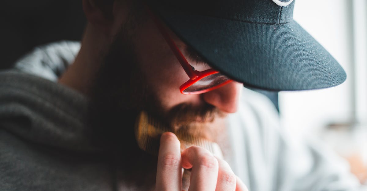 Is there a daily fare cap on the Taipei MRT? - Stylish male hipster combing beard