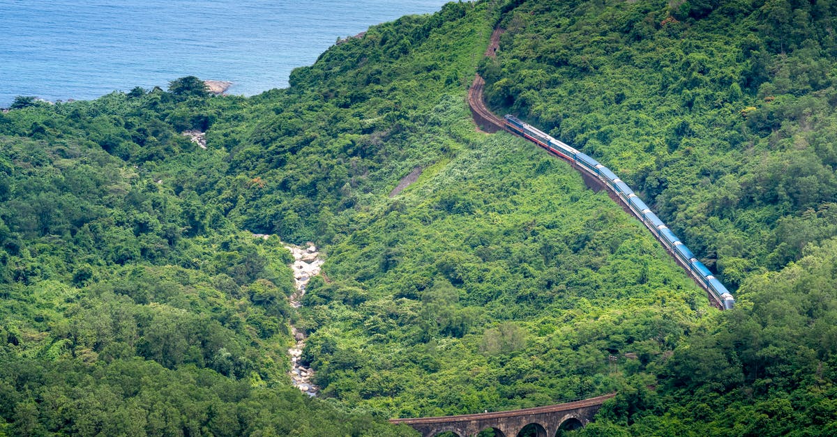 Is there a direct train from Bucharest to Istanbul? - Train driving on railway in green mountains