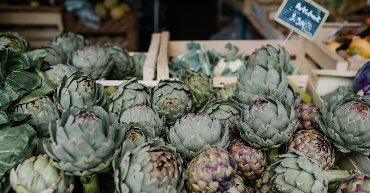 Is there a hawker stall selling local food in walking distance from Changi airport? - Ripe artichokes in boxes in market