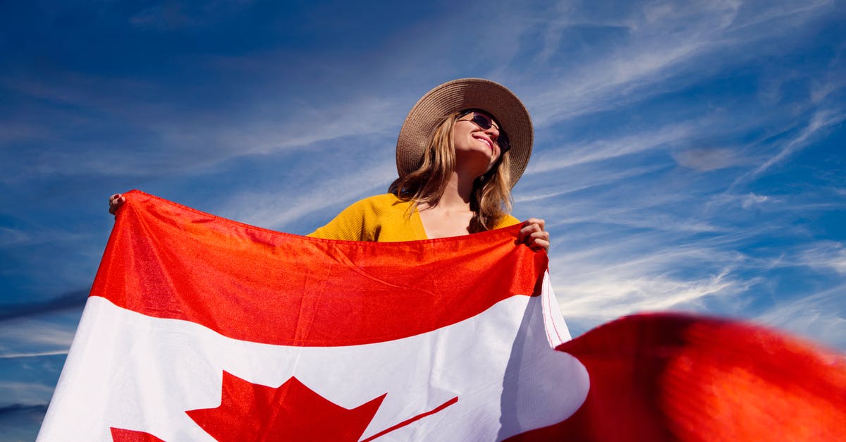 Is there a list of countries that do not reset the "clock" for Canada visits? - A Photograph of a Woman Holding a Canadian Flag