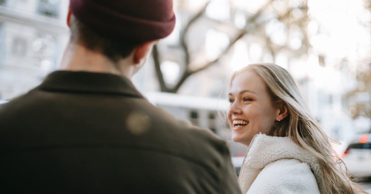 Is there a list of Greyhound partner bus carriers? - Smiling couple in outerwear standing in street near transport and building in daytime in town