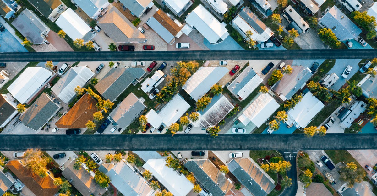 Is there a major car rental company in the U.S. that also rents roof top cargo box? - Aerial view of many similar roofs of residential buildings with growing trees and parked cars near narrow asphalt roads in contemporary town in daylight Is there a major car rental company in the U.S. that also rents roof top cargo box? - Aerial view of many similar roofs of residential buildings with growing trees and parked cars near narrow asphalt roads in contemporary town in daylight