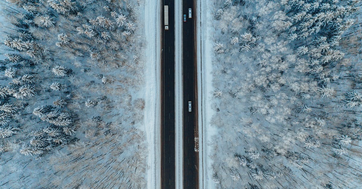 Is there a map that shows Austrian winter road closures? - Aerial View of a Highway in a Frosted Forest