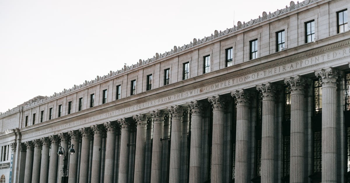 Is there a Post Office in Heathrow? - From below of facade of famous James A Farley Post Office with columns and windows in center of New York at daytime