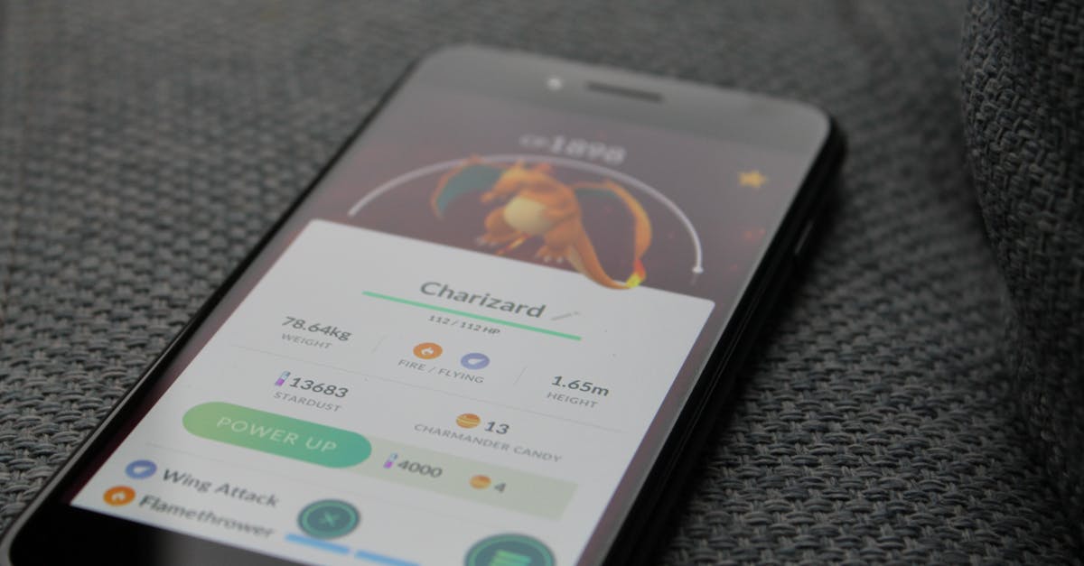 Is there a practical way to change the phone number in Uber app when arriving at a country? - Turned-on Iphone Displaying Pokemon Go Charizard Application