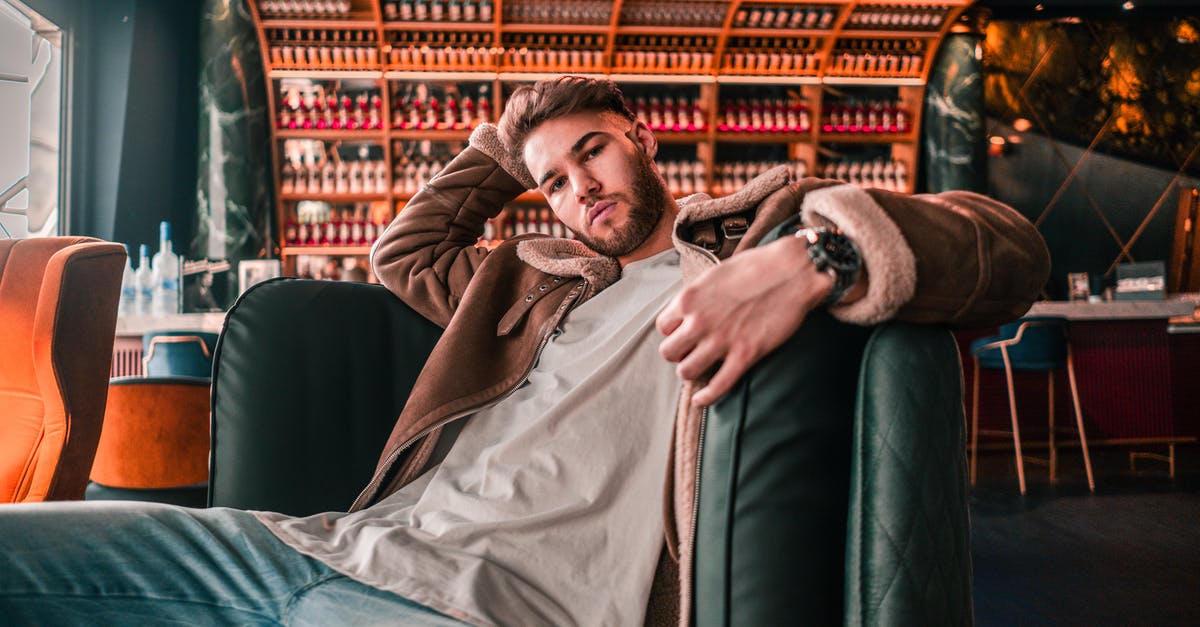 Is there a prayer room in Frankfurt airport? - Man in Brown Coat Lying on Black Leather Couch