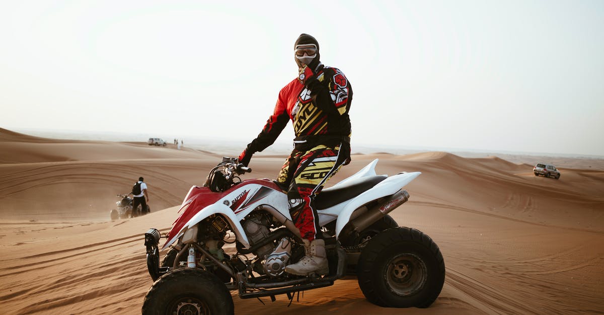 Is there a risk with flights stopping off in Russia? - Man in helmet on quad bike in desert