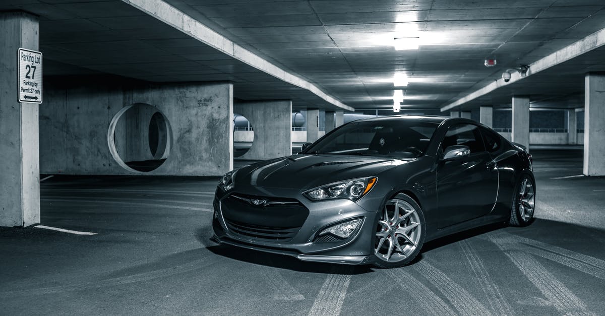 Is there a search engine for renting an electric car? - Selective color of gray luxury sports car parked on floor in center of car park