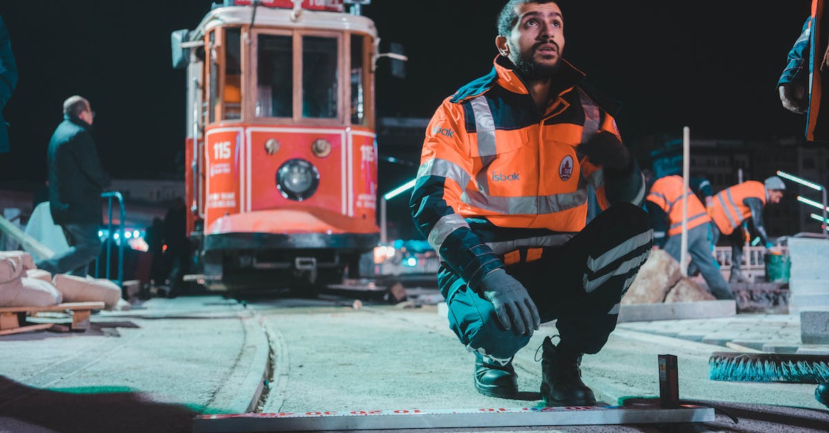 Is there a site like Jetsetter for France/Europe? - Man in Orange and Black Zip Up Jacket and Black Pants Sitting on Red and Yellow