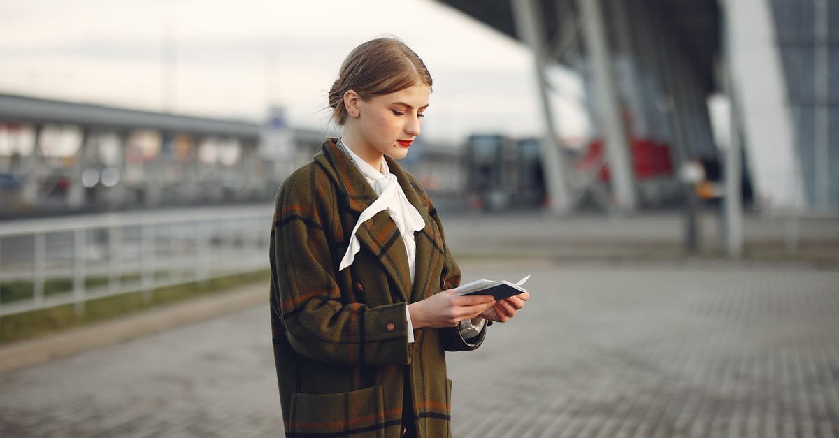 Is there a UK train ticket that allows for a interrupted journey between Birmingham-Reading-Gatwick? - Attentive female passenger wearing trendy plaid coat and white blouse checking passport and ticket standing on pavement near modern building of airport outside Is there a UK train ticket that allows for a interrupted journey between Birmingham-Reading-Gatwick? - Attentive female passenger wearing trendy plaid coat and white blouse checking passport and ticket standing on pavement near modern building of airport outside