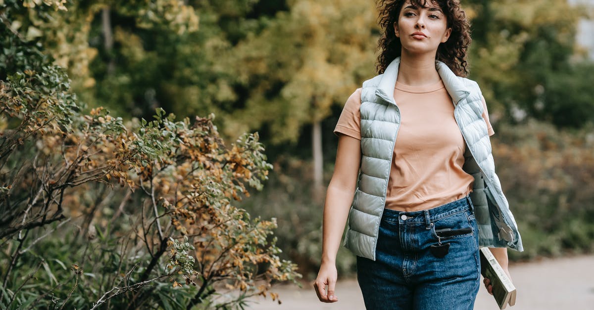 Is there a way to exclude third-party booking websites on Skyscanner? - Pensive woman in casual clothes walking alone on walkway near green trees placed in city park and looking away in daytime