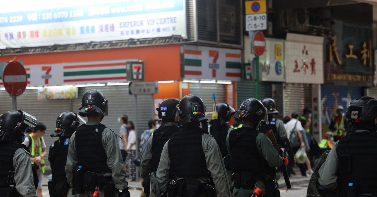 Is there a way to "secure" a GDS reservation? - Crowd of police walking on street