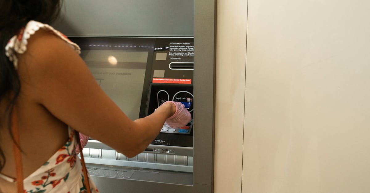 Is there an ATM at Tel-Aviv airport? - Woman Using An Automated Teller Machine
