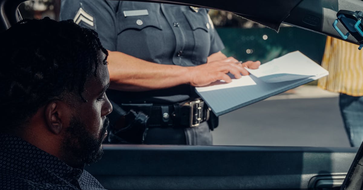 Is there an easyJet ticket office in Schönefeld? - Police Officer Standing Next to the Car Window 