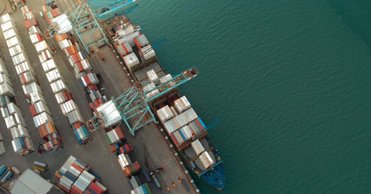 Is there any free WiFi network available at the boarding port in Buenos Aires (RENAPER Buquebus) for the Buquebus boat service? - Top view of harbor with containers and cargo ships located near calm rippling sea water