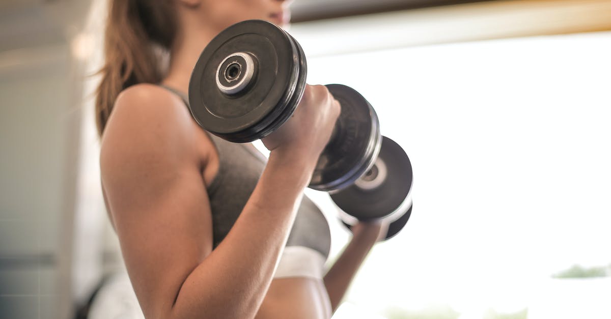 Is there any limit on the weight of a luggage? - Woman in Gray Sports Bra Holding Black Dumbbell