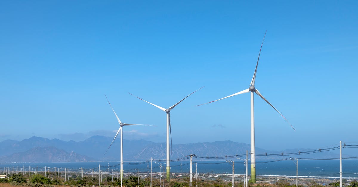 Is there any similar alternative to Zanzibar, in Tanzania? - Scenery view of wind turbines in row on terrain with plants against ocean and mounts in daytime