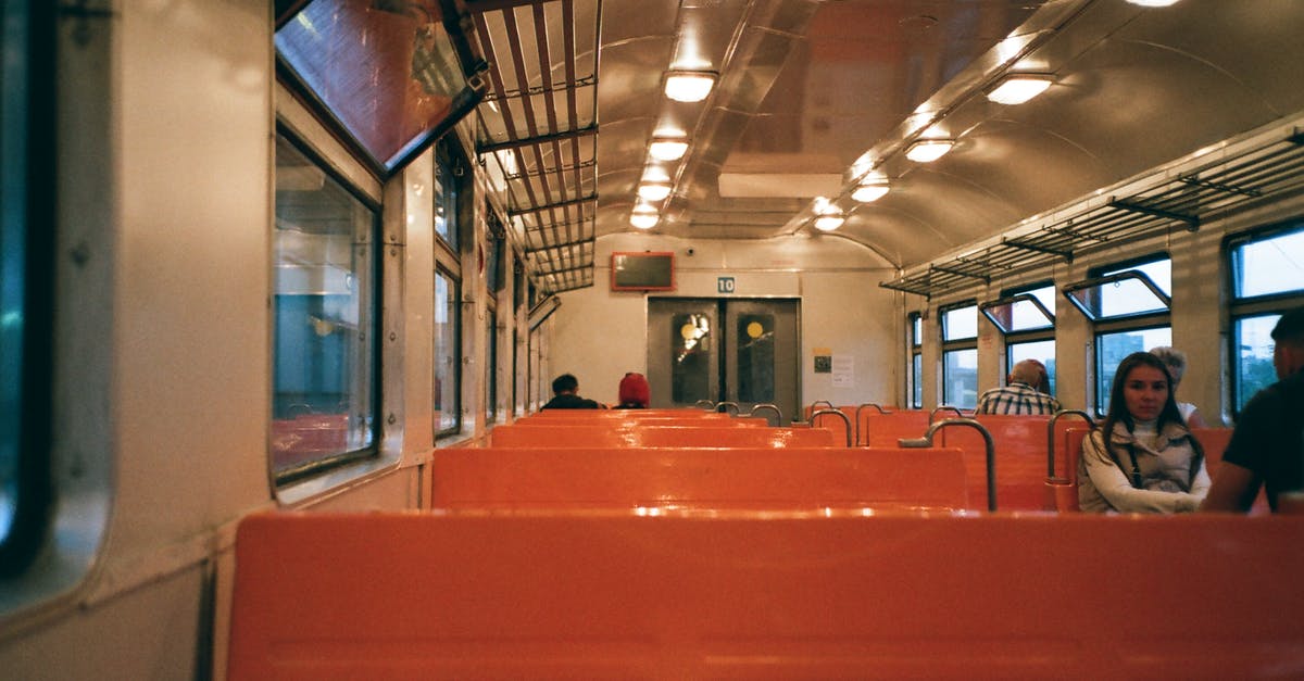 Is there currently train service between Turkey and Iran? - Interior of train wagon with metal shelves ad bright seats with passengers riding