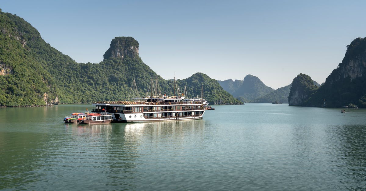 Is there ferry service from Vietnam to Borneo? - White and Blue Ship on the Lake