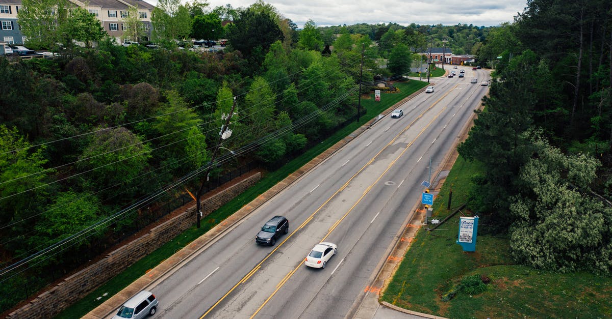 Is there no direct straight road from Wailea to Route 37? - From above modern cars driving along asphalt road surrounded with green trees in suburb area