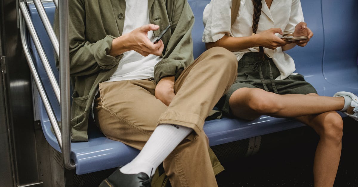 Is there really only 1 public transport connection a day between Ljubljana and Kranjska Gora? - Crop couple browsing smartphones in subway carriage