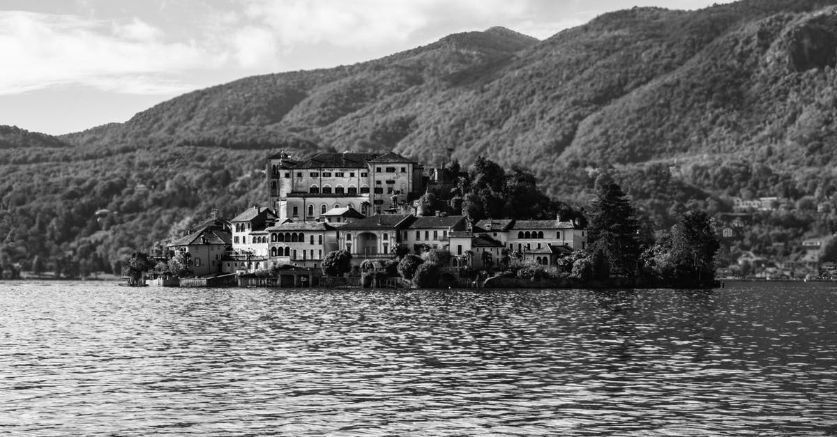 Is there such a thing as a "guarantee" by a Schengen resident - Grayscale Photo of Building Near Body of Water