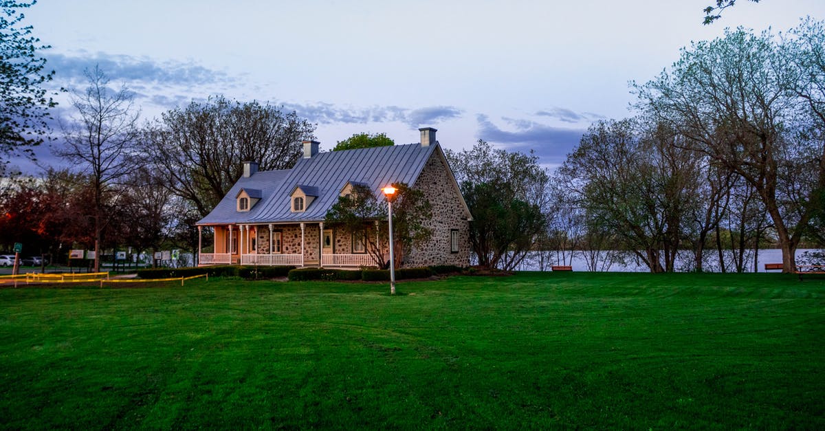 Is this airliner-shaped lake real? - Grey Concrete House Near Bare Trees