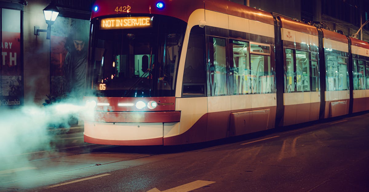 Is this train cancelled or not? - Red and White Tram on Road during Night Time