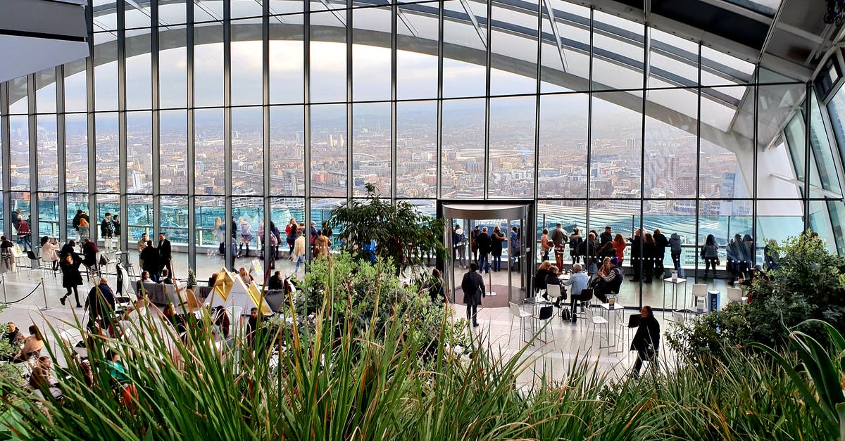 Is tipping customary in London in a restaurant? - People Inside The Sky Garden With View Of Cityscape