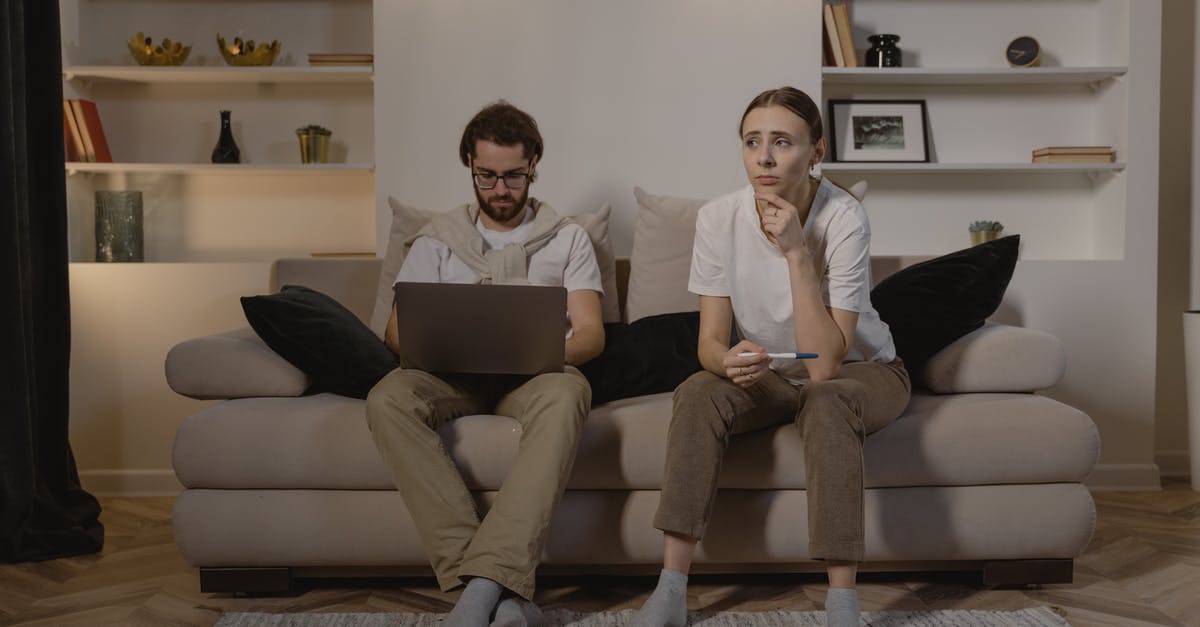 Is tipping expected in Indonesia? - Man and Woman Sitting on Couch