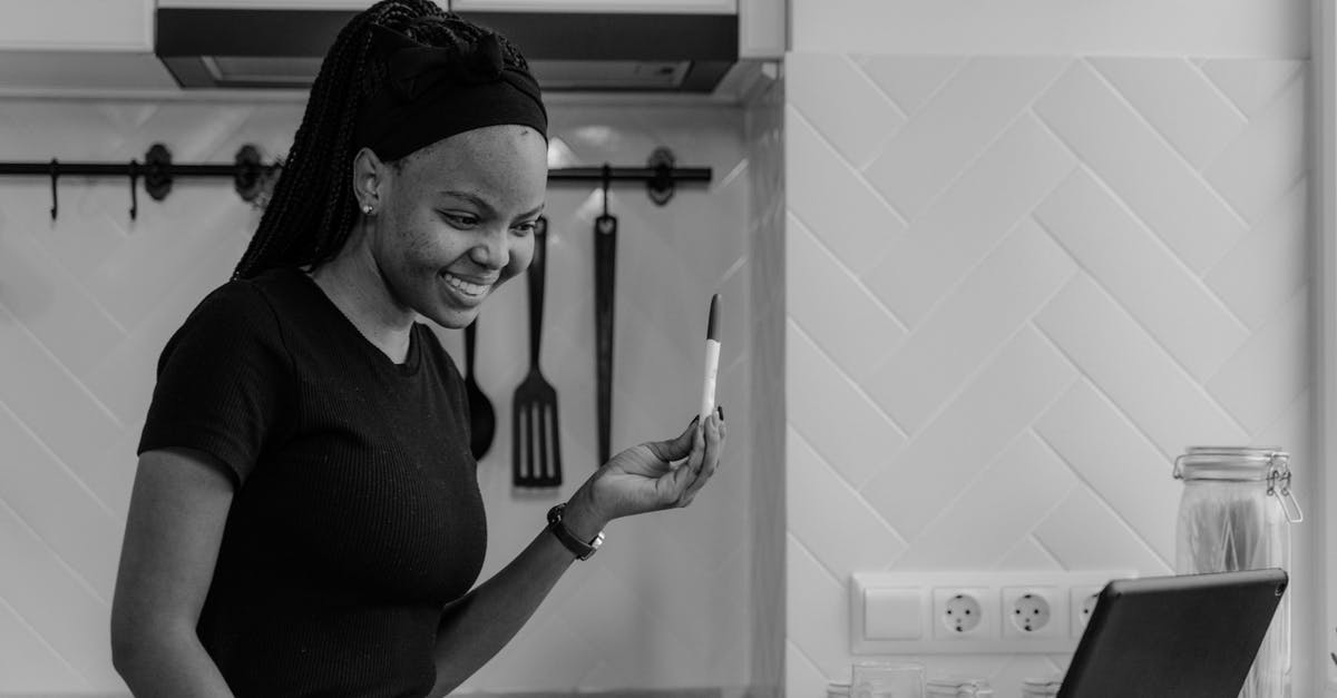 Is tipping expected in Indonesia? - Woman in Black Long Sleeve Shirt Standing in Front of Sink