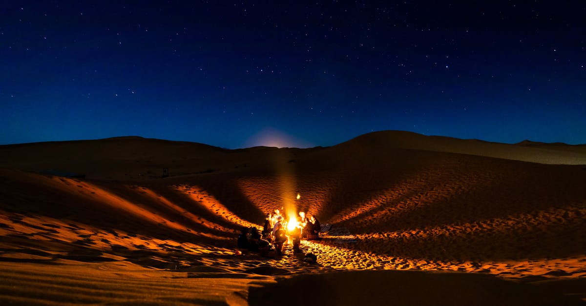 Is traveling by train in the night in Morocco safe? - People Having Bonfire at Desert at Night