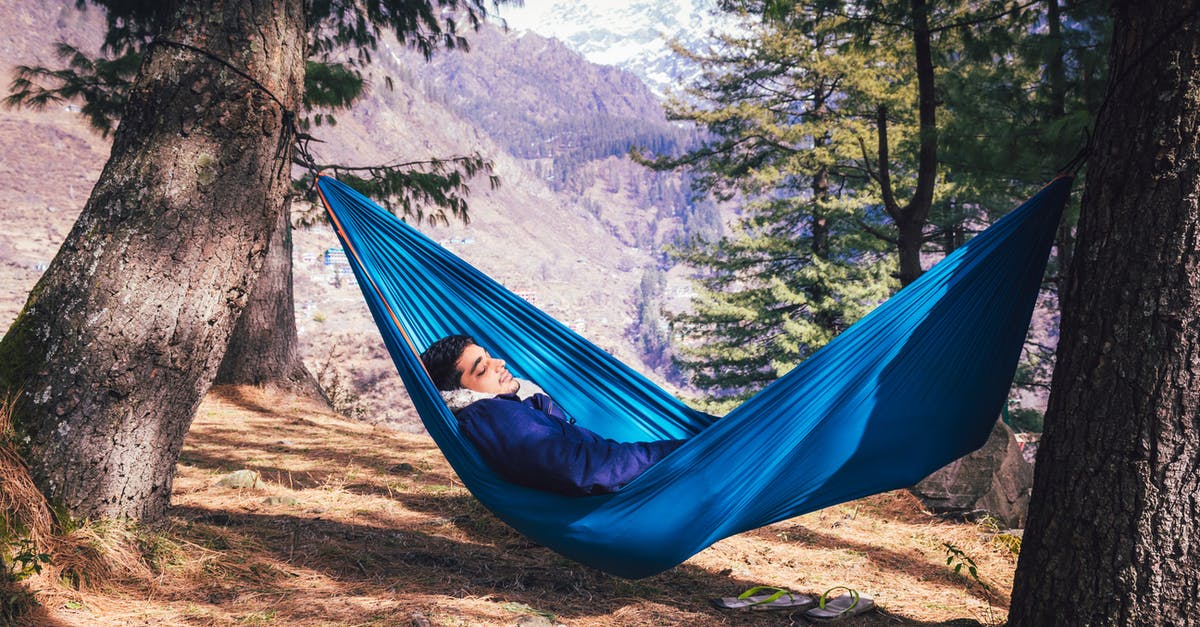 Is travelling allowed in Uttarakhand without E-pass? - A Male Traveler Sleeping in a Blue Hammock