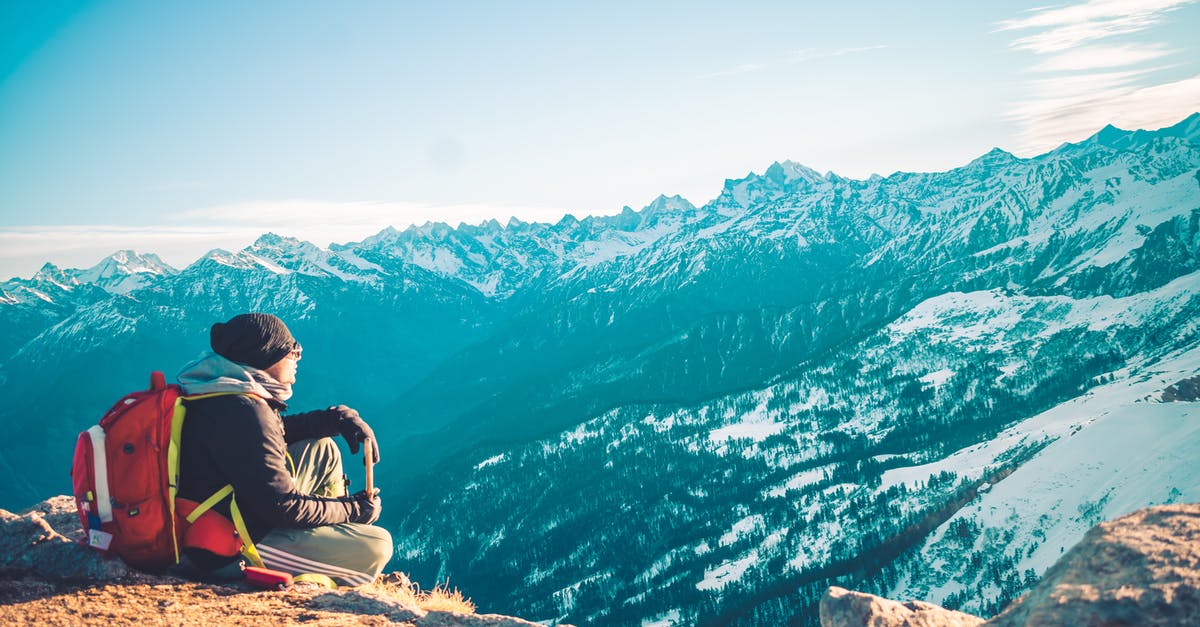 Is travelling allowed in Uttarakhand without E-pass? - Person Sitting on Brown Soil of Mountain Peak