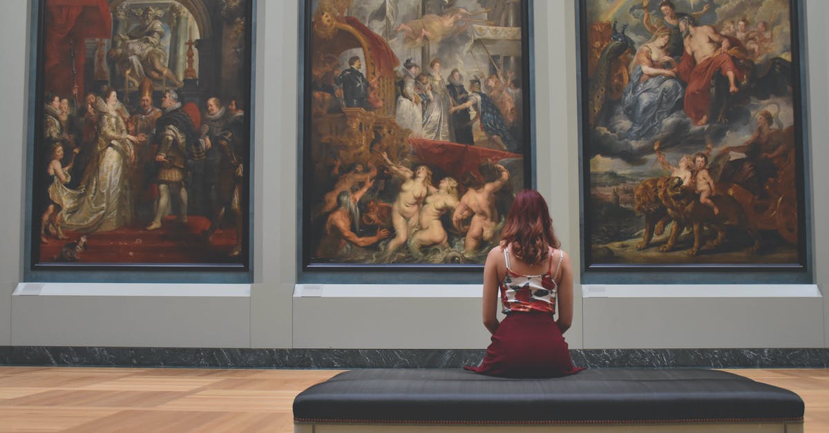 Islamic art museums / Galleries in Dubai - Woman Sitting on Ottoman in Front of Three Paintings