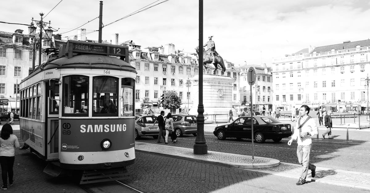 Issue while reissue of Portugal Railway ticket - Grayscale Photography of Man Walking Outdoors