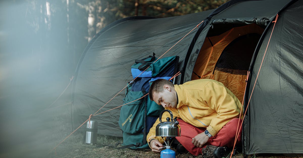 Issues when camping during trek in Georgia? - Child in Yellow Jacket Holding Clear Glass Mug