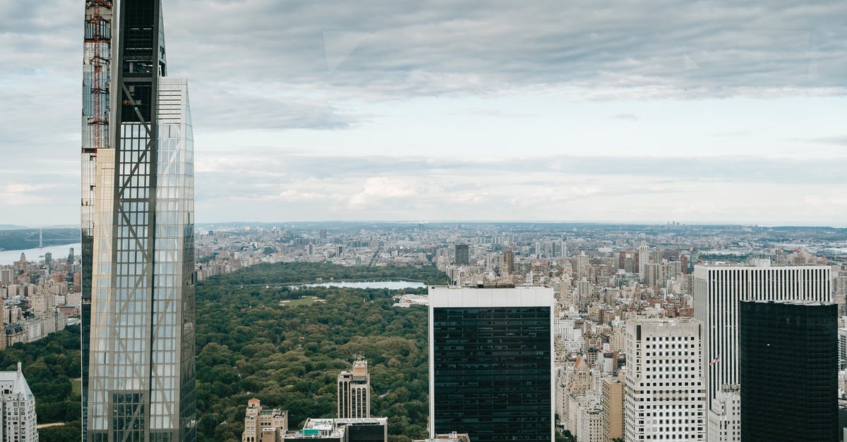 J-1 visa, but residency outside US [closed] - Modern skyscrapers against cloudy sky