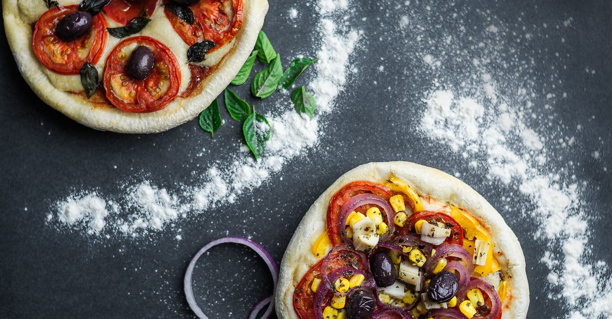 Japanese Corn and Mayo Pizza - Pizza with tomatoes and cheese on table with flour