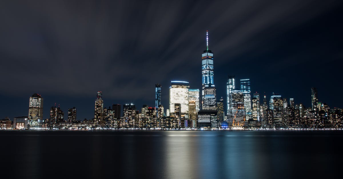 JFK airport to downtown Manhattan at night - High-rise Buildings at Night Near Sea