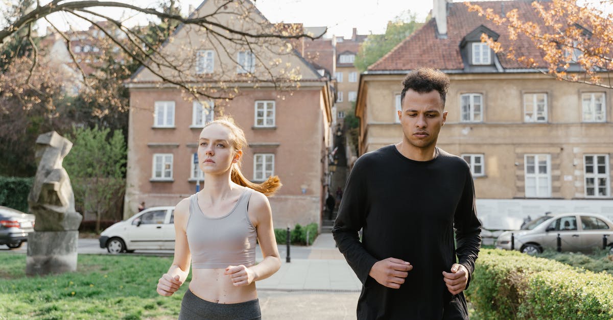 Jogging in Budapest without my passport - Man and Woman Standing on Sidewalk