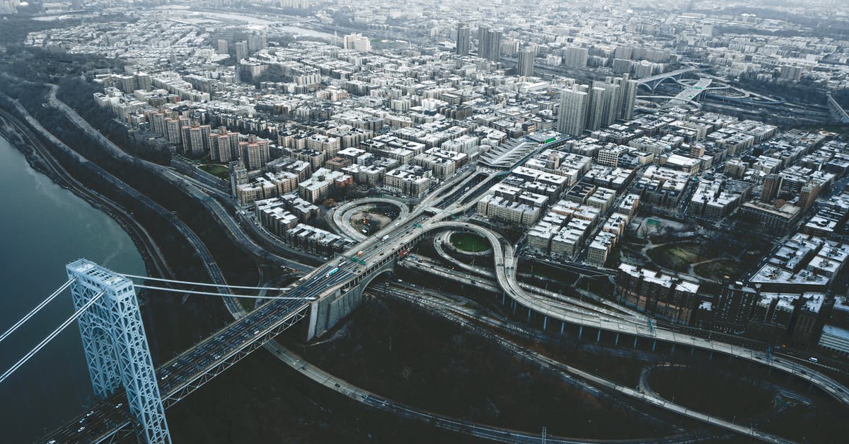 Journey from India (Bombay/Mumbai) to USA on ship - Drone view of George Washington Bridge crossing river and connecting districts of New York City against cloudy sky